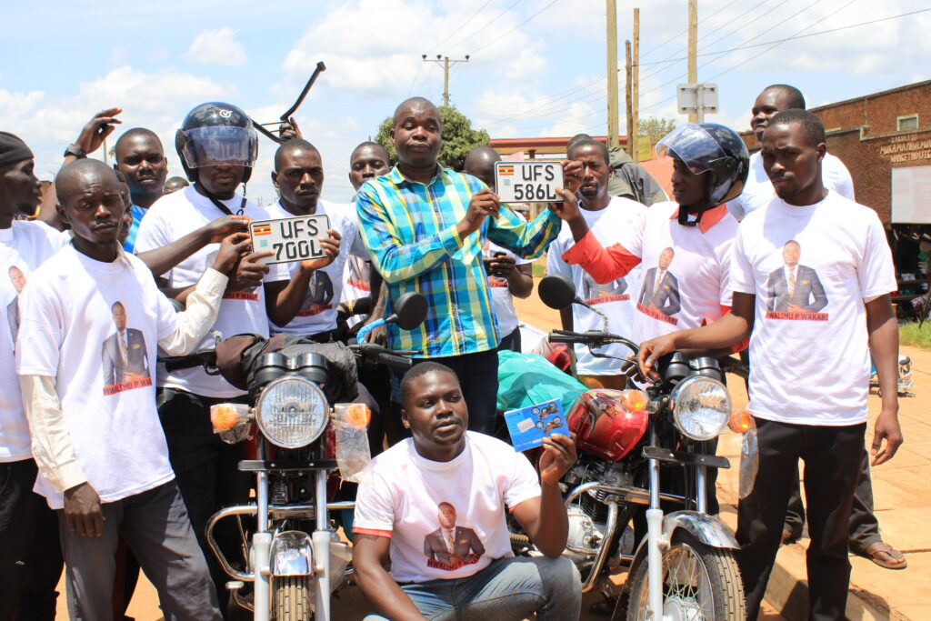 Bugahya County Member of Parliament, Pius Rujumba Wakabi, hands over new motorcycles to Bulindi Boda Boda and Kitoba Sub-County bricklaying Association in Hoima district on September 27. Photo: Robert Atuhairwe.