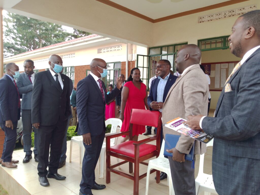 Principal-Judge-Flavian-Zeija-chats-with-Kikuube-district-chairperson-Peter-Banura-during-the-launch-of-Hoima-High-Court-Crcuit-on-Tuesday.-Photo-by-Peace-Lawrence-Ayesigwa.