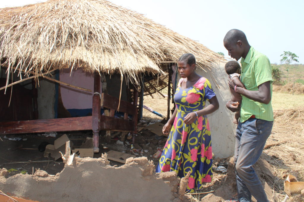 A couple looks at a house which was destroyed during eviction in Kapapi sub-county in Hoima district on Wednesday. Credit: Robert Atuhairwe/The Albertine Journal