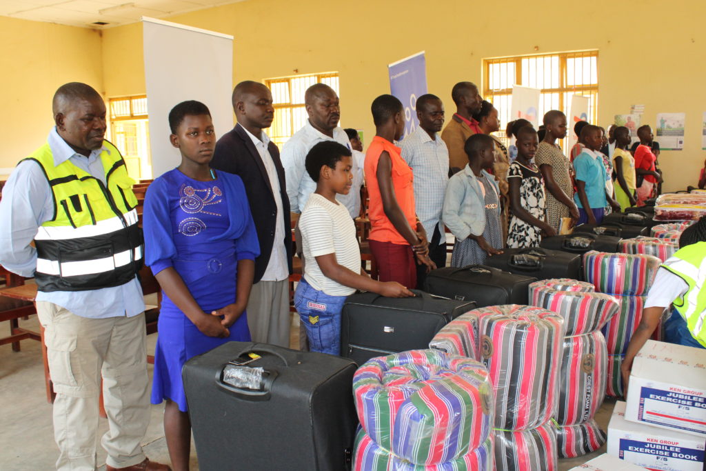 Beneficiaries receive scholastic materials at Buliisa district local government headquarters by TotalEnergies EP Uganda on Wednesday, February 15, 2023. Credit: Robert Atuhairwe/The Albertine Journal