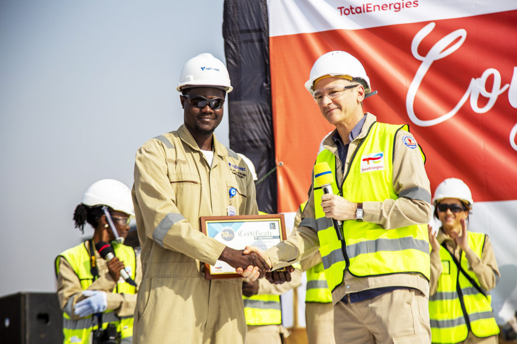 Philippe Groueix (C) General Manager TotalEnergies EP Uganda (R) hands over a certificate of appreciation to one of the contractors for achieving crucial health and safety industry milestone at a function in the firm’s operation area in Ngwedo Sub-County in Buliisa district on Tuesday.