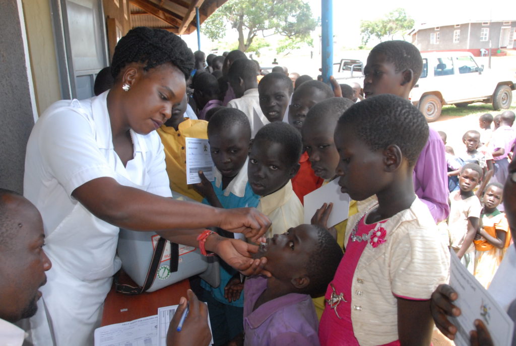 Lilian Tuhaise a nurse at Buseruka health centre III in Hoima district offers an Oral Cholera Vaccination in 2015. Credit: Robert Atuhairwe/The Albertine Journal