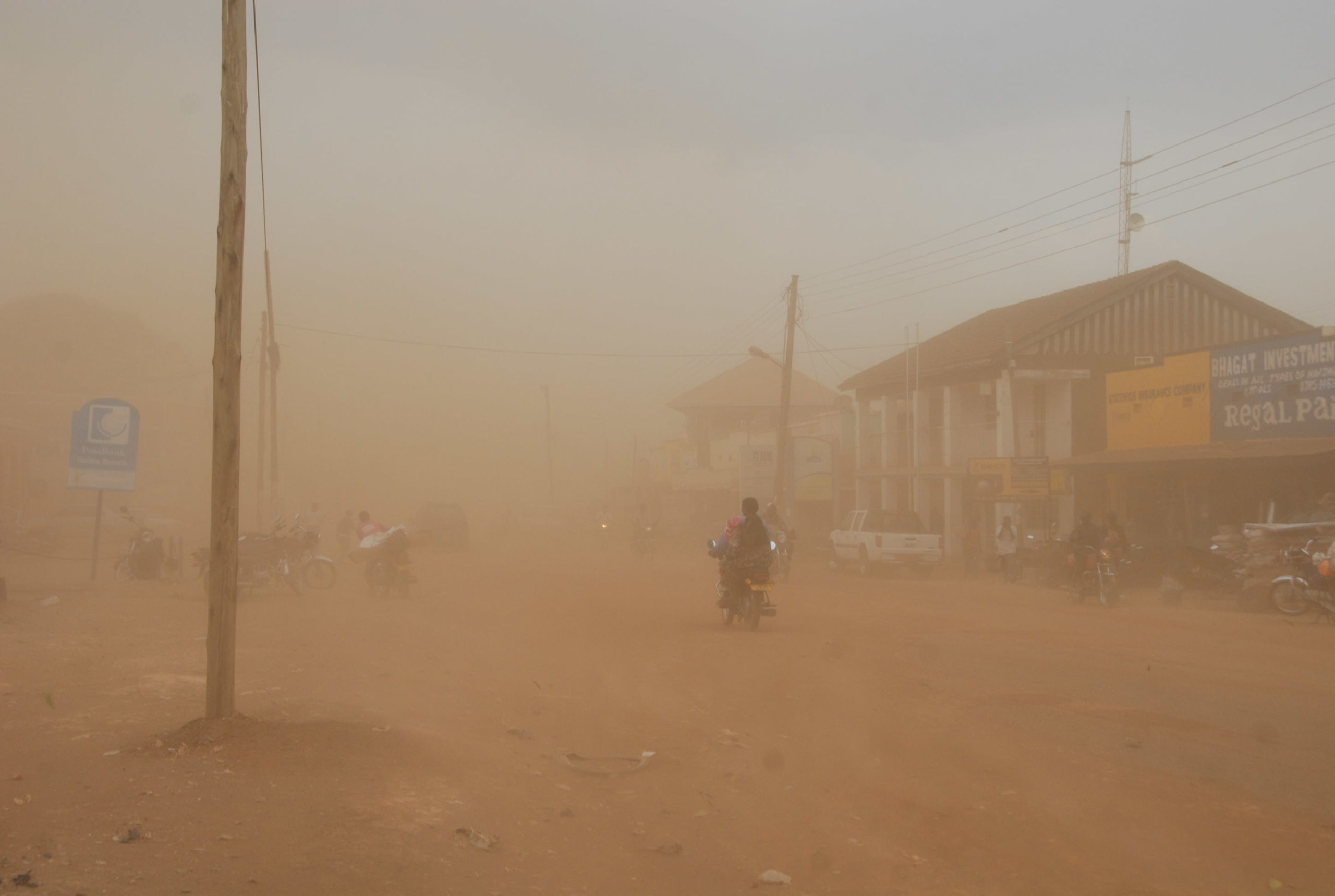 A dusty storm in Hoima City on which forced shop owners to close as pedestrians raced off on Jan 22, 2014. Photo: Robert Atuhairwe/The Albertine Journal.