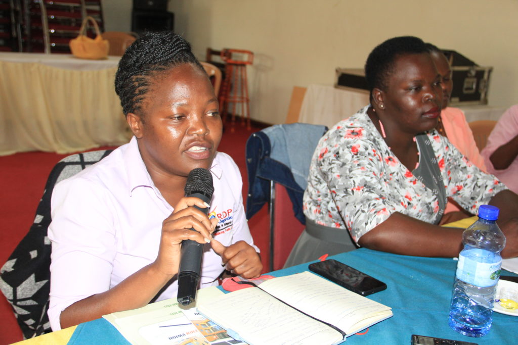 Barbra Anyango Wabwire, a monitoring and evaluation officer at the Recreation for Development and Peace speaks during the event at Kolping Hotel in Hoima City. Photo: Robert Atuhairwe.