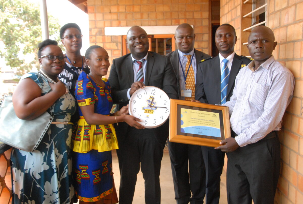 Fred Wakisa (extreme right), the executive director Kolping Holdings receiving an award from Uganda Revenue Authority (URA) for being tax compliance in the 2017-2018 financial. Credit: Robert Atuhairwe/The Albertine Journal.