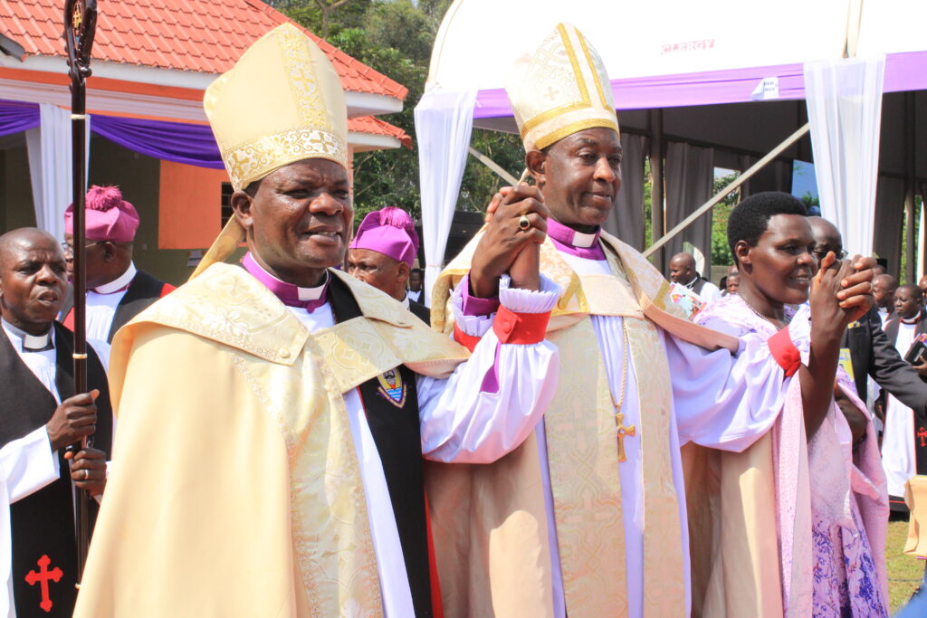 Archbishop Stephen Samuel Mugalu Kazimba presents the newly consecrated Bishop, Jacob Ateirweho-left. (Photo by Robert Atuhairwe/The Albertine Journal)