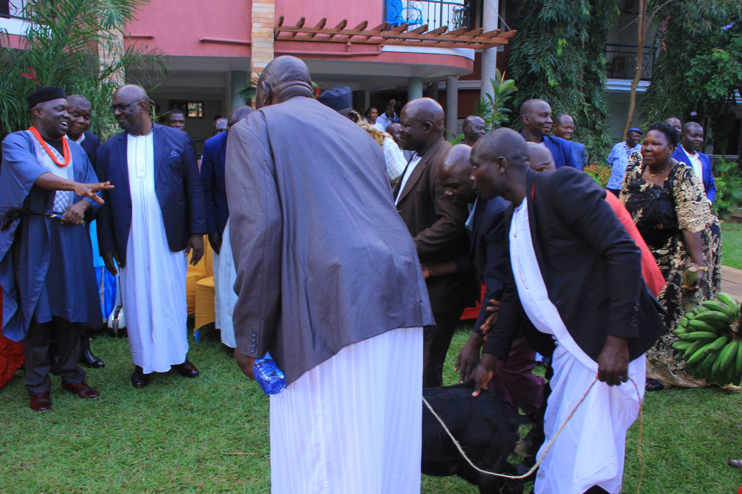 The King of Alur Kingdom Phillip Olarker Ubimu Rauni III chats with Byakutaga as his subjects present him with presents at De Place Hotel in Hoima City on Friday. Credit: Robert Atuhairwe/The Albertine Journal