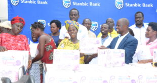 Alled Ronald Akugizibwe (right) handing over a mama kit to the expectant mothers. Photo: Yosam Gucwaki/The Albertine Journal