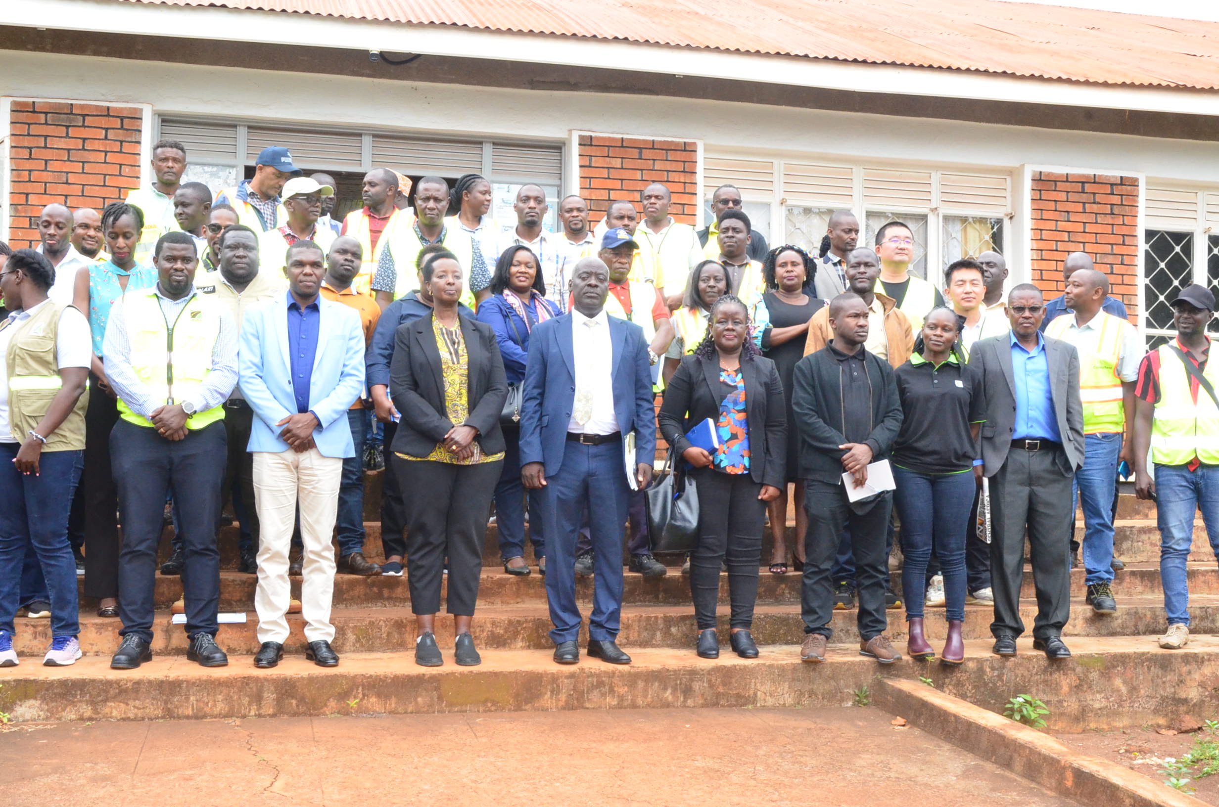 Kagina (fourth left in front row) and her team in a group phot with the district leadership. Credit: Yosam Gucwaki/The Albertine Journal