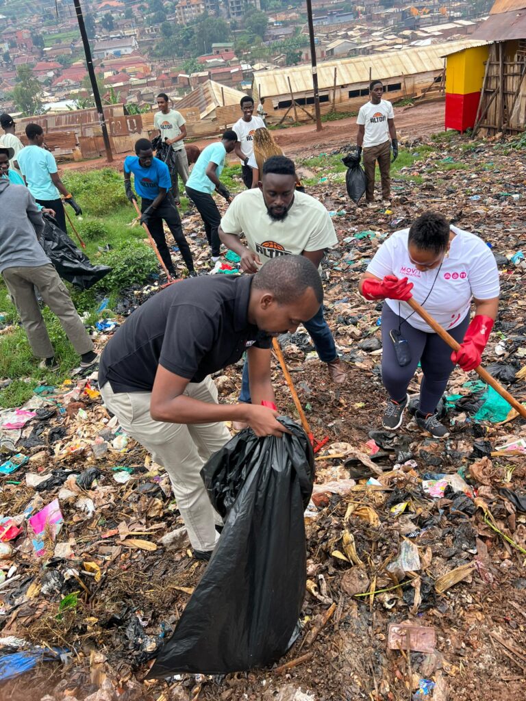 Musa Abdul Rugumayo (in black t-shirt), and other participants during the cleaning exercise of Acholi Quarters on Thursday. Credit: Courtesy.