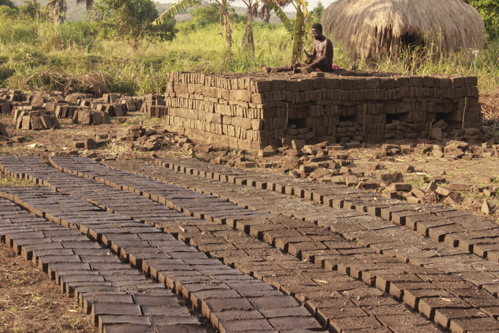 A brick maker in Dei Sub-County in Pakwatch district. Credit: Robert Atuhairwe/The Albertine Journal.